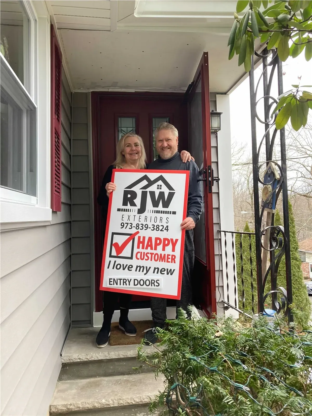 couple posing in front of door